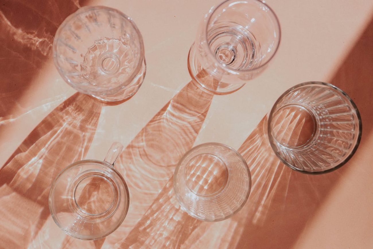 elegant glassware shadows on beige surface
